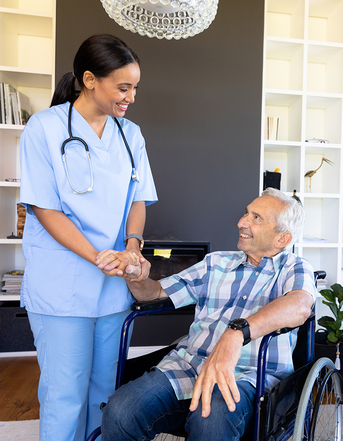 Biracial female health worker supporting caucasian senior man sitting on the wheelchair. Medical care and retirement senior lifestyle concept